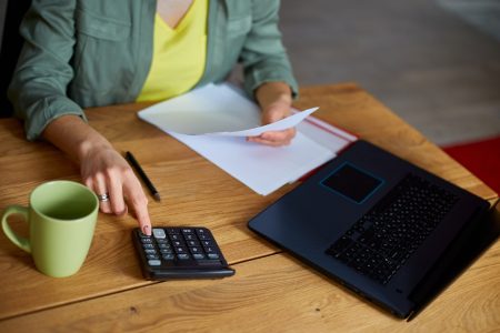 close-up-of-woman-sit-calculate-expenses-on-calcul-2021-09-04-11-59-06-utc-min